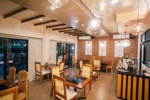 a dining room with a table and chairs at Marieli Suites near Panglao International Airport in Panglao Island