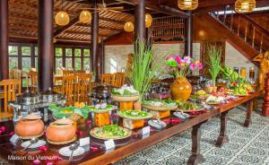 a buffet of food on a table in a restaurant at Maison Du VietNam Resort & Spa in Phu Quoc