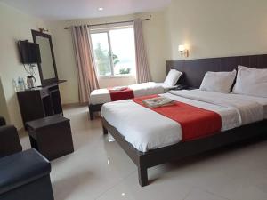 een hotelkamer met 2 bedden en een televisie bij Hotel My Dream in Pokhara