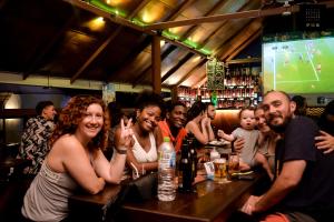 a group of people sitting at a bar at Sizzle Sports Club in Kandy