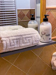 a shelf with two bottles of soap and a towel at Grazalema - Casita La Calma - Incredible views, Clima Frio-Calor, Wifi & Private Parking optional in Grazalema