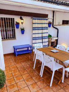 a patio with a wooden table and chairs at Grazalema - Casita La Calma - Incredible views, Clima Frio-Calor, Wifi & Private Parking optional in Grazalema