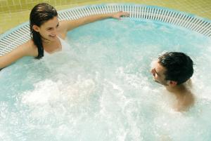 a man and a woman in a hot tub at BELVEDERE - das BIO HOTEL Garni & SuiteHotel am Edersee ! Unser Geschenk für Sie, auch die GästeCard GrimmHeimat! in Waldeck