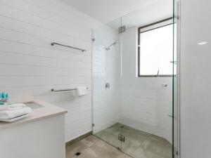 a bathroom with a glass shower and a sink at 21 1 Quamby Place Noosa Heads in Noosa Heads +11 photos