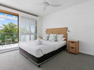 a bedroom with a large bed and a large window at 21 1 Quamby Place Noosa Heads in Noosa Heads