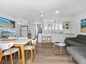 a kitchen and living room with a table and chairs at 21 1 Quamby Place Noosa Heads in Noosa Heads