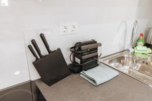 a kitchen counter with a sink with a bag on it at Your Cozy Sapphire Apartment in Athens