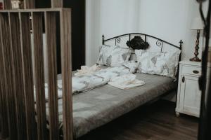 a bed with white sheets and pillows on it at Urbino Casa in Cluj-Napoca