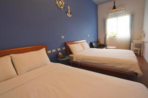 En eller flere senge i et værelse på Taitung city-cottage B&B
