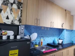 a kitchen with a sink and a microwave at Aj booking in Manila