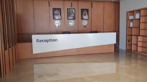 a reception desk in a room with pictures on the wall at Al Rayyan Tower in Jeddah