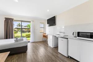 a hotel room with a bed and a kitchen at Lemon Tree Passage Motel in Lemon Tree Passage