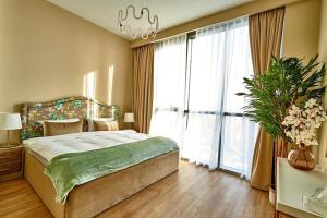 a bedroom with a bed and a large window at Magnificent 3BR with Full Burj Khalifa & Fountain view in Dubai