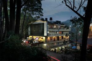 a building is lit up at night at Las Palmas in Munnar