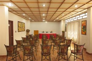 a room with a bunch of chairs and a table at Las Palmas in Munnar