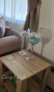 a wine glass sitting on a table next to a couch at Luxury holiday lodge Lyons Robin Hood Rhyl Wales in Rhyl