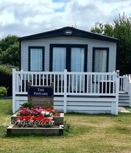 a tiny house with a sign in front of it at Luxury holiday lodge Lyons Robin Hood Rhyl Wales in Rhyl