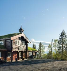 a log cabin with a grass roof at NARVIKFJELLET Camp 291 in Narvik