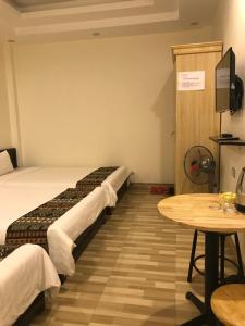 um quarto de hotel com uma cama e uma mesa em Minh Anh House em Sapa