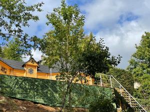 a wooden house with a staircase in front of it at Alsace kota évasion & Spa la canopée in Mollkirch