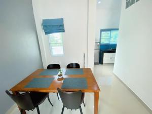 a dining room table and chairs in a room at Origin hua hin poolvilla in Hua Hin