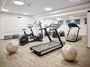 a gym with several exercise bikes in a room at Hotel Shandranj in Tesero