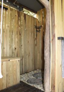 a wooden fence with a stone floor and a wall at The Wild - Glamping in Wilderness in Wilderness