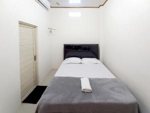 una camera bianca con un letto di Griya Mutiara Serayu Syariah near Univ Merdeka Madiun Mitra RedDoorz a Madiun