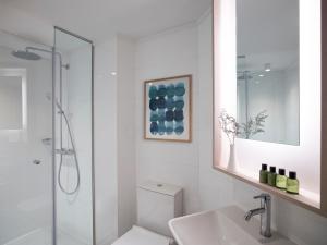 a bathroom with a shower and a toilet and a sink at Rhodes Bay Hotel & Spa in Ixia