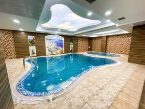 a large swimming pool in a hotel room with a large swimming pool at Premier Palace Baku in Baku