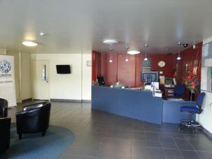 a lobby of a hospital with a counter and chairs at Abbots Hamilton – Hotel and Conference Centre in Hamilton