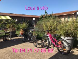 two bikes parked in front of a building at Abel Hôtel in Langeac