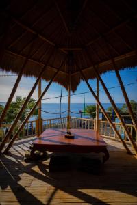 艾湄灣的住宿－Aroma De La Mer，甲板上草伞下的桌子