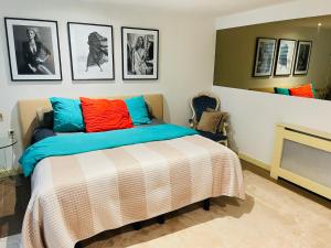 a bedroom with a bed with colorful pillows at Red light district B & B canal view in Amsterdam