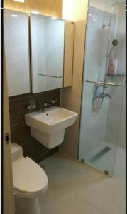 a bathroom with a toilet and a sink and a shower at Aquarius Building I 2043 in Geoje