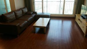 a living room with a leather couch and a coffee table at Aquarius Building I 2043 in Geoje