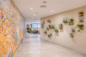 a hallway with plants on the wall at Citadines Ramblas Barcelona in Barcelona