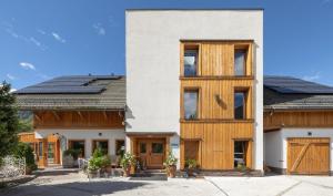 a house with wooden doors and windows at Hotel Lipa in Kranjska Gora