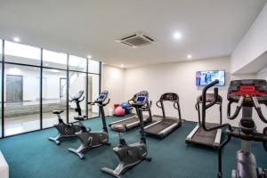 a gym with treadmills and cardio equipment in a room at Sea Views Broadbeach in Gold Coast