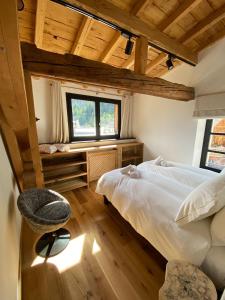 ein Schlafzimmer mit einem weißen Bett und einem Fenster in der Unterkunft Le Marti in Chamonix-Mont-Blanc