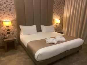 a hotel room with a bed with towels on it at Klima Hotel Milano Fiere in Milan