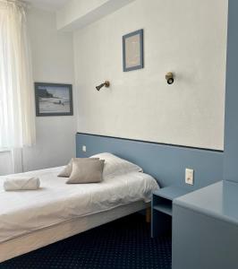 a hotel room with a bed and a table at HOTEL KAN AVEL in Saint-Lunaire