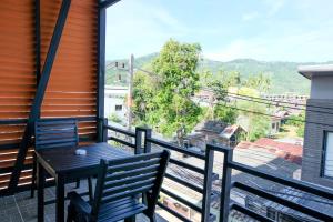 a table and chairs on a balcony with a view at Baanpoon Apartment in Chaweng