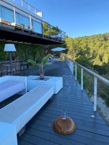 a wooden boardwalk with benches and a wooden bowl on it at Design Studio Cap Rubio Ibiza in Na Xamena