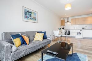 a living room with a couch and a table at Bright and cozy 2-Bed Apartment in Dagenham in Dagenham