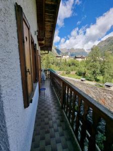 a balcony of a house with a view of the mountains at CASA NONNA RINA in Alagna Valsesia