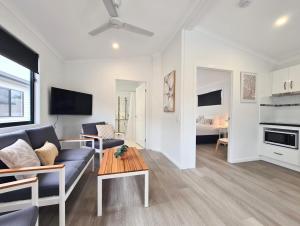 uma sala de estar com um sofá e uma mesa em Club Byron Accommodation em Byron Bay