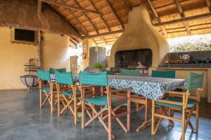 a dining room with a table and chairs and a fireplace at El Morado Guest Farm in White River