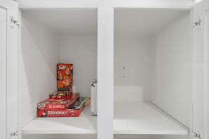 a white refrigerator with some snacks in it at Pool Escape Nr Med Center, Galleria, Nrg Games in Houston