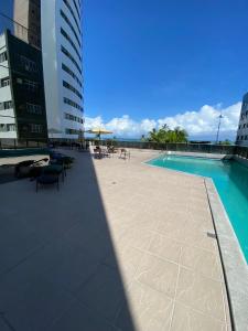 a swimming pool on the roof of a building at Beach Class Internacional apartamento in Recife